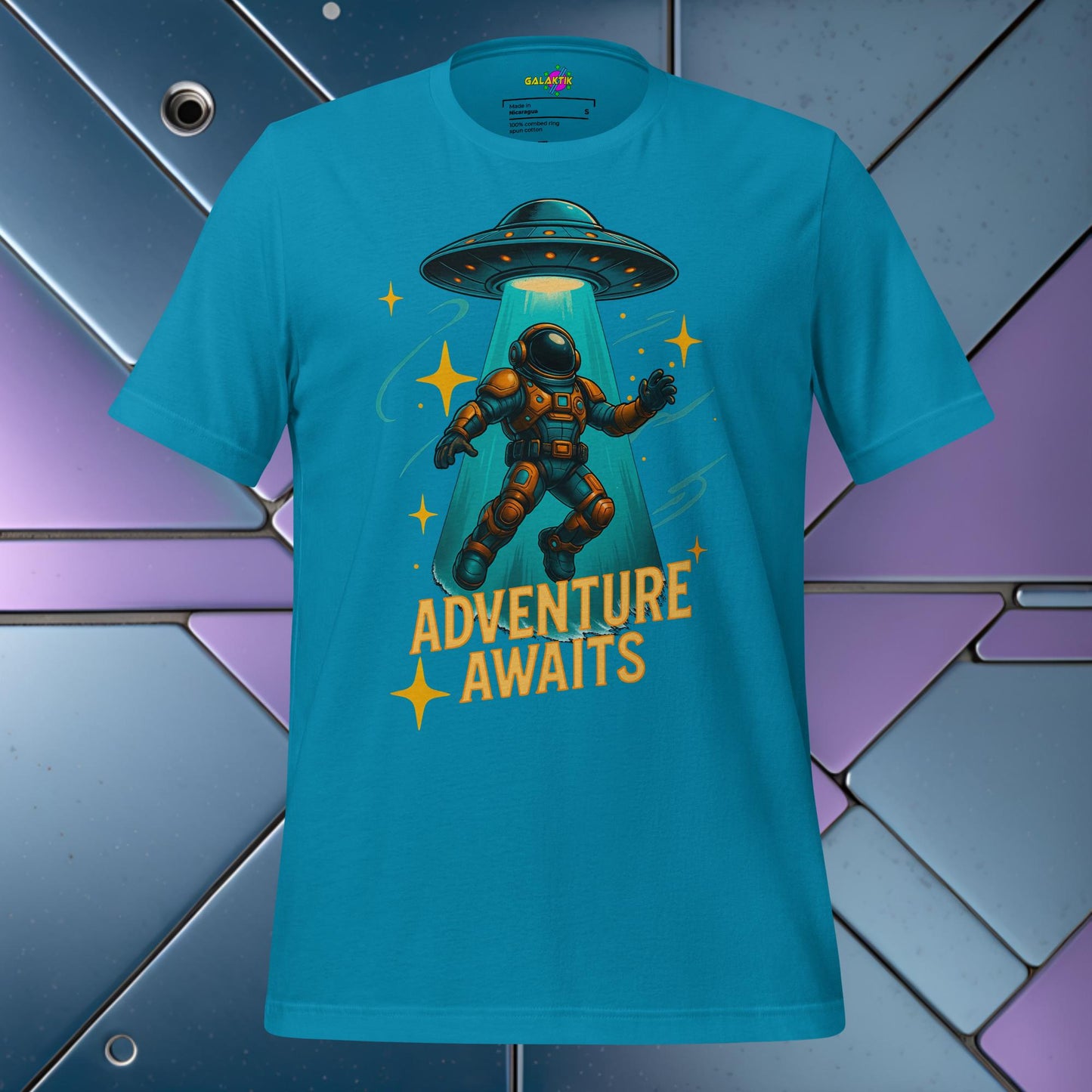 Blue t-shirt with an astronaut and UFO graphic and 'Adventure Awaits' text on a colorful geometric background.