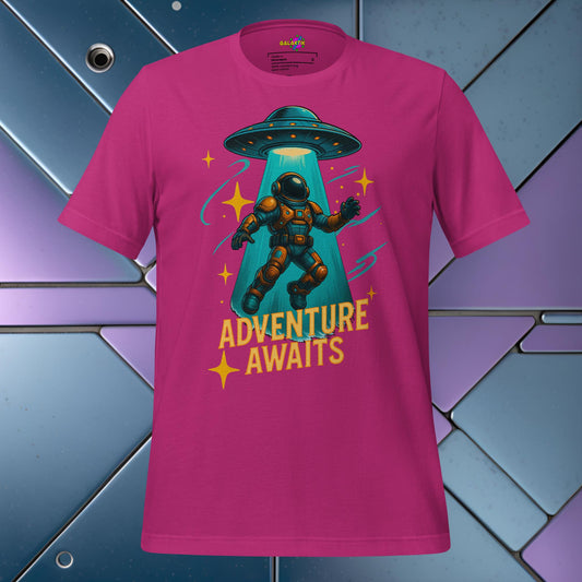 Pink t-shirt with an astronaut and UFO graphic and 'Adventure Awaits' text on a colorful geometric background.