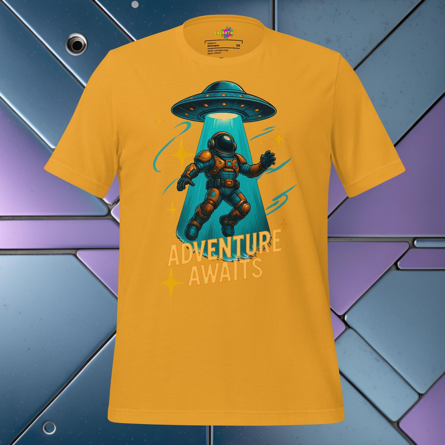 Yellow t-shirt with an astronaut and UFO graphic and 'Adventure Awaits' text on a colorful geometric background.
