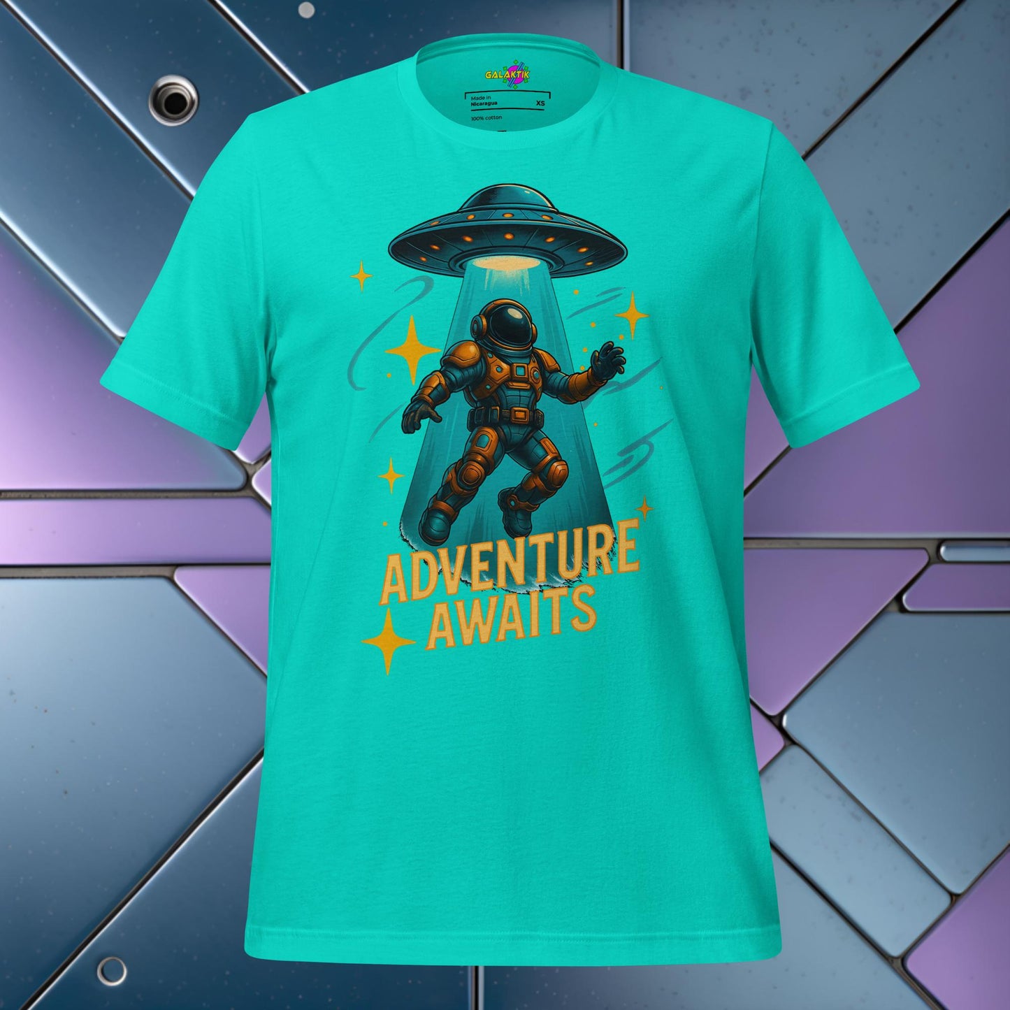 Teal t-shirt with an astronaut and UFO graphic and 'Adventure Awaits' text on a colorful geometric background.
