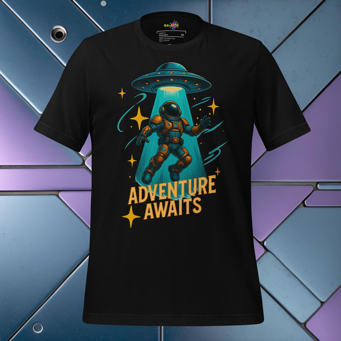 Black t-shirt with an astronaut and UFO graphic and 'Adventure Awaits' text on a colorful geometric background